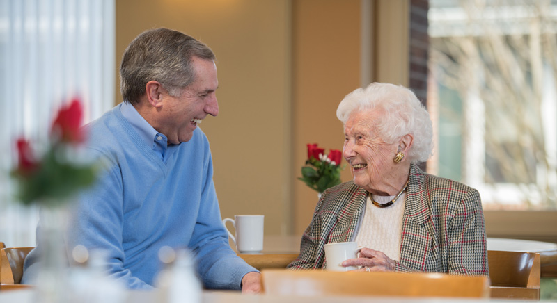 two seniors talking over coffee